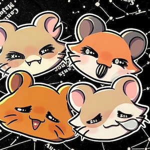 May include: Four cartoon hamster stickers with different expressions. The hamsters are in shades of tan and orange, with black eyes and white highlights. The background is black with a white constellation pattern.