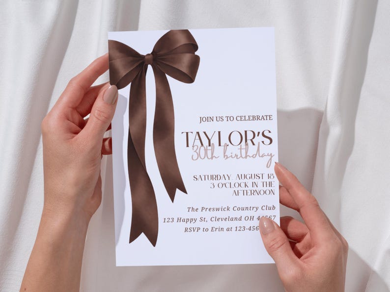 Traditional elegant birthday invitation with oversized espresso ribbon and soft script lettering, perfect for a personalized milestone celebration.
