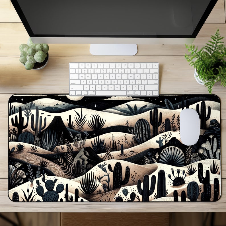 May include: Black and white desert landscape mouse pad with a stylized cactus design. The mouse pad has a black border and a beige background.