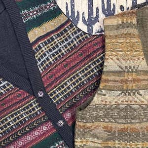 May include: Three different patterned knit vests. The first vest is black with a red, green, and gold geometric pattern. The second vest is cream with a red and white geometric pattern and a cactus design. The third vest is brown with a green, gold, and brown geometric pattern.