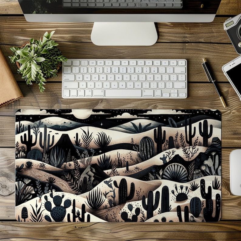 May include: A black and white illustrated desert scene with cacti, mountains, and a starry night sky. The design is printed on a rectangular mouse pad.