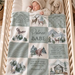 May include: A soft baby blanket featuring a patchwork design with sage green and cream squares. It displays illustrations of a deer, bear, rabbit, and forest landscapes, alongside the name Palmer Babe and religious verses from Joshua 1:9 and Psalm 139.
