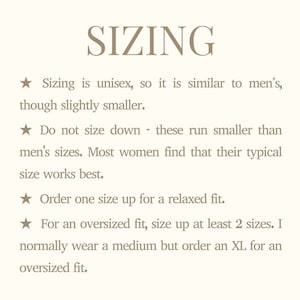 May include: A cream-colored page with the word "SIZING" in a serif font. Text below details sizing advice: unisex sizing, do not size down, order one size up for a relaxed fit, and size up at least two sizes for an oversized fit.