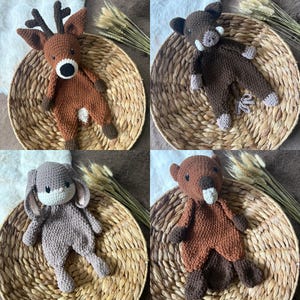 May include: Four crocheted stuffed animals: a deer, a boar, a bunny, and a beaver. The animals are brown and beige and have embroidered facial features. They are sitting on woven baskets.