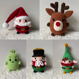 May include: Five crocheted Christmas ornaments: a red Santa Claus, a brown reindeer, a green elf, a green Grinch-like character, and a green and red nutcracker.