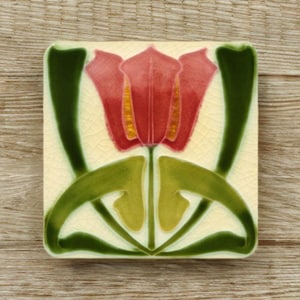 May include: Square ceramic tile with a stylized red tulip design, green leaves and stems on a cream background. The tile has a crackle glaze finish. Decorative tile for home decor, suitable for kitchens or bathrooms.