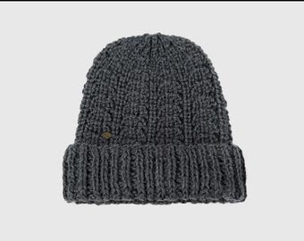 May include: A gray knitted beanie with a small diamond-shaped logo on the front.