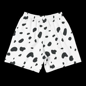 May include: White athletic shorts with a black Dalmatian spot pattern. The shorts have an elastic waistband and a relaxed fit, suitable for various activities. The fabric appears to be lightweight and breathable.