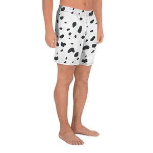 May include: White athletic shorts with a black dalmatian spot pattern. The shorts have an elastic waistband and a relaxed fit. The shorts are made of a lightweight, breathable fabric, perfect for workouts or casual wear.