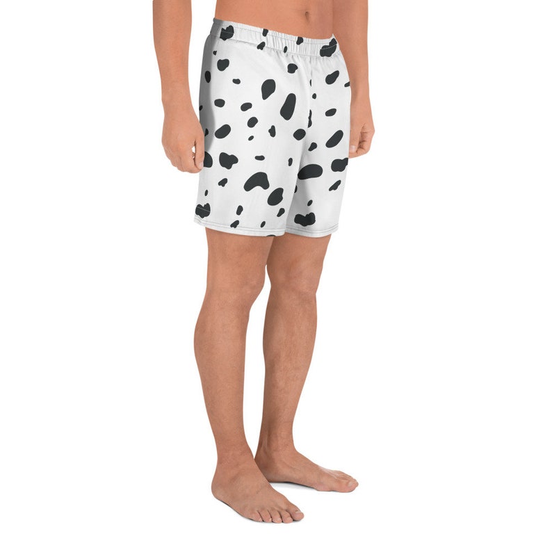 May include: White athletic shorts with a black dalmatian spot pattern. The shorts have an elastic waistband and a relaxed fit. The shorts are made of a lightweight, breathable fabric, perfect for workouts or casual wear.