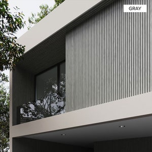 May include: A modern home exterior with a gray wood slat wall and a balcony with a glass railing. The balcony has a large window with a view of trees.