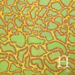 May include: Abstract pattern fabric with a green background and yellow and brown swirls. The fabric has a textured look and feel. The fabric is ideal for crafting and home decor projects.
