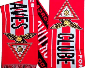 May include: Red and white scarf with the text "AVES" and "CLUBE" in black. The scarf features a triangular emblem with a soccer ball and a golden eagle. The ends have white and red fringe.