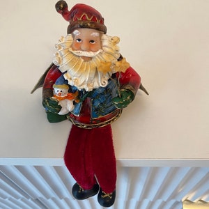 Vintage old fashion Dangling leg Santa Claus with tin cape