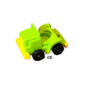 May include: A bright green toy truck with black wheels and yellow accents. The truck has a small hole in the top and the number 620 is printed on the side.