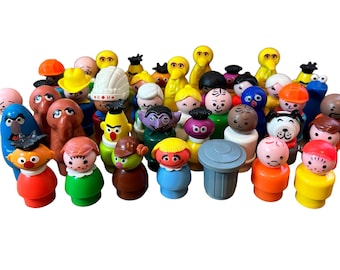 May include: A collection of vintage plastic figurines, including Sesame Street characters, Big Bird, Elmo, Cookie Monster, and others. The figurines are in various colors, including red, blue, yellow, green, and brown.