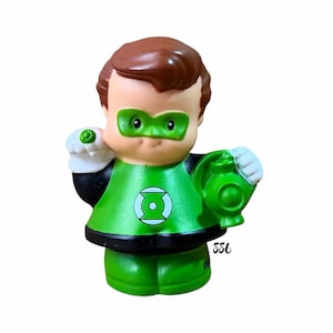 May include: A Green Lantern figurine with brown hair, a green eye mask, and a green suit featuring a circular emblem on the chest. The figure has white gloves, a green ring on the right hand, and holds a green lantern in the left hand. The number 886 is visible.