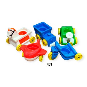 May include: A set of five vintage Little People toys, including a white rocking horse, a red airplane, a blue train, a green car, and a blue motorcycle. Each toy has a cup-shaped seat.