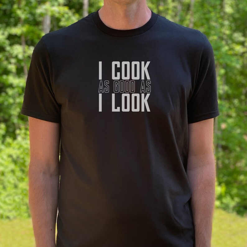 May include: A black t-shirt with white text that reads "I COOK AS GOOD AS I LOOK".