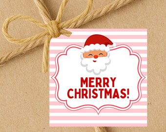May include: A square gift tag with a Santa Claus illustration and the words "MERRY CHRISTMAS!" in red. The tag has a pink and white striped background and a decorative red border. A brown twine bow is tied around the tag.