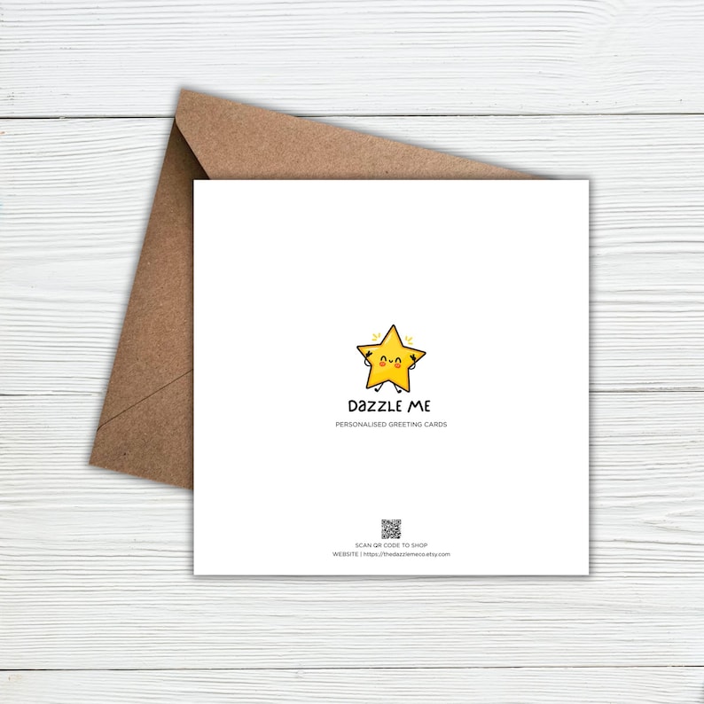 May include: A square white greeting card with a brown envelope. The card features a yellow star character with a smiling face, the text DAZZLE ME PERSONALISED GREETING CARDS, a small QR code, and the text SCAN QR CODE TO SHOP WEBSITE | thedazzleme.etsy.com.