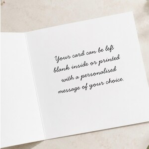 May include: A white greeting card with black cursive text printed on the inside. The text reads: Your card can be left blank inside or printed with a personalised message of your choice. The card is open, showing the interior surface clearly.