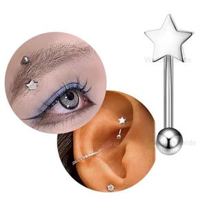 May include: A silver star-shaped barbell piercing with a ball end. The image also shows close-ups of piercings on an eyebrow and ear, including a star-shaped stud and a curved barbell.
