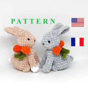 May include: Two crocheted bunny plush toys, one beige and one grey, both with orange carrot accents. The toys are sitting on a white surface. The word "PATTERN" is written in green letters above the toys.