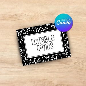 May include: A black and white notebook-style card with the words "EDITABLE CARDS" in a handwritten font. A blue and purple circle with the text "EDIT IN Canva" is in the upper right corner. The card is on a light brown wooden surface.