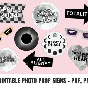 May include: Printable photo booth props for a total solar eclipse event. The props feature black and white designs with text like "April 8, 2024", "Total Eclipse of the Heart", "I Got Mooned", and "It's Only a Phase".