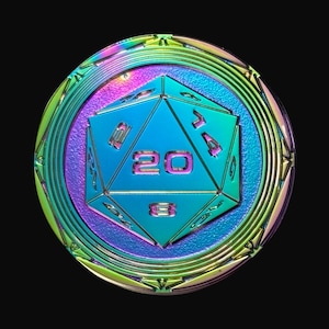May include: A round, iridescent metal coin with a blue, twenty-sided die in the center. The die has the number 20 in the center. The coin has a rainbow-colored border and a black background.