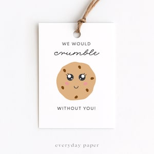 May include: A white gift tag with a brown string, featuring the text "WE WOULD crumble WITHOUT YOU!" and a cartoon cookie illustration with a smiling face. The tag also includes the text "everyday paper".