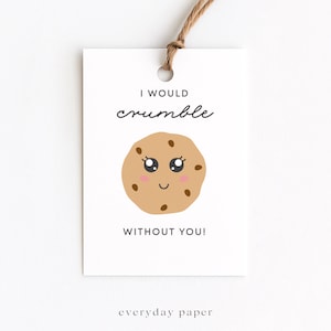 May include: A white gift tag with a brown string. The tag features the text "I would crumble without you!" above a cartoon cookie with a smiling face. The words "everyday paper" are at the bottom.