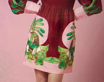 May include: A woman wearing a maroon dress with a pink and green floral print. The dress has puffed sleeves and a square neckline. She is wearing gold sandals.