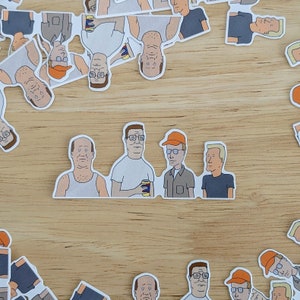Op de afbeelding: Een set van 11 stickers met cartoonfiguren met verschillende karakters met verschillende gezichtsuitdrukkingen en kapsels. De stickers zijn gedrukt op wit papier en hebben een glanzende afwerking.