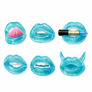 May include: A collection of six blue-tinted lip sculptures. One has a pink tongue, another holds a lipstick, and a third has devil horns. The lips are detailed with texture and set against a white background.