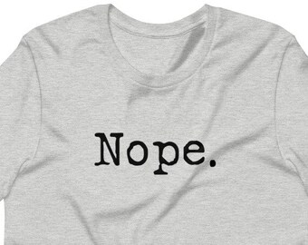 May include: A heather grey t-shirt with the word "Nope." printed in black.