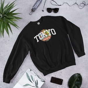 May include: Black sweatshirt with a white graphic of the text "TOKYO MARATHON" with a colorful circle design.