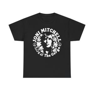 May include: Black t-shirt with a white graphic of Joni Mitchell's face surrounded by flowers and the text "Joni Mitchell Live at The Gorge".