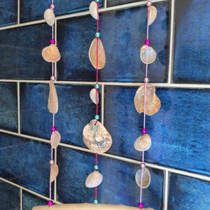 Cockle and oyster shell beaded triple string mobile/windchime.