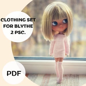 May include: A Blythe doll wearing a light pink knitted sweater dress and matching knee-high socks. The doll has blonde hair and blue eyes. The image includes the text "CLOTHING SET FOR BLYTHE 2 PSC." and "PDF".
