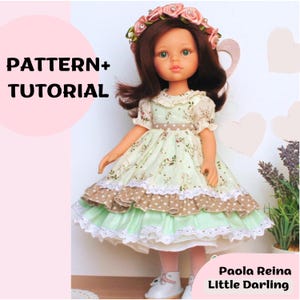 May include: A doll wearing a floral print dress with a layered skirt, a floral headband, and white shoes. The text "PATTERN+ TUTORIAL" is on the left, and "Paola Reina Little Darling" is on the bottom right.