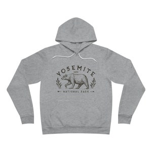 May include: A grey hooded sweatshirt with a black and white graphic print of a bear and the text "Yosemite 1890 National Park".