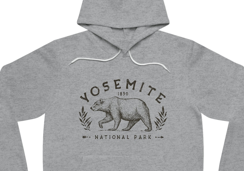 May include: Grey hooded sweatshirt with a black graphic print of a bear walking in front of a wreath with the text "Yosemite 1890 National Park".