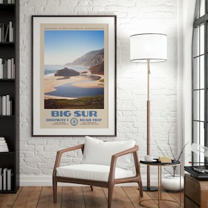 May include: A framed travel poster featuring a scenic landscape of Big Sur, California, with a sandy beach, blue water, and coastal cliffs. The text reads BIG SUR, HIGHWAY 1, ROAD TRIP, LOS PADRES NATIONAL FOREST, and SAN SIMEON TO CARMEL-BY-THE-SEA.