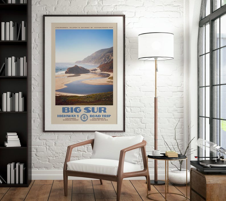 May include: A framed travel poster featuring a scenic landscape of Big Sur, California, with a sandy beach, blue water, and coastal cliffs. The text reads BIG SUR, HIGHWAY 1, ROAD TRIP, LOS PADRES NATIONAL FOREST, and SAN SIMEON TO CARMEL-BY-THE-SEA.