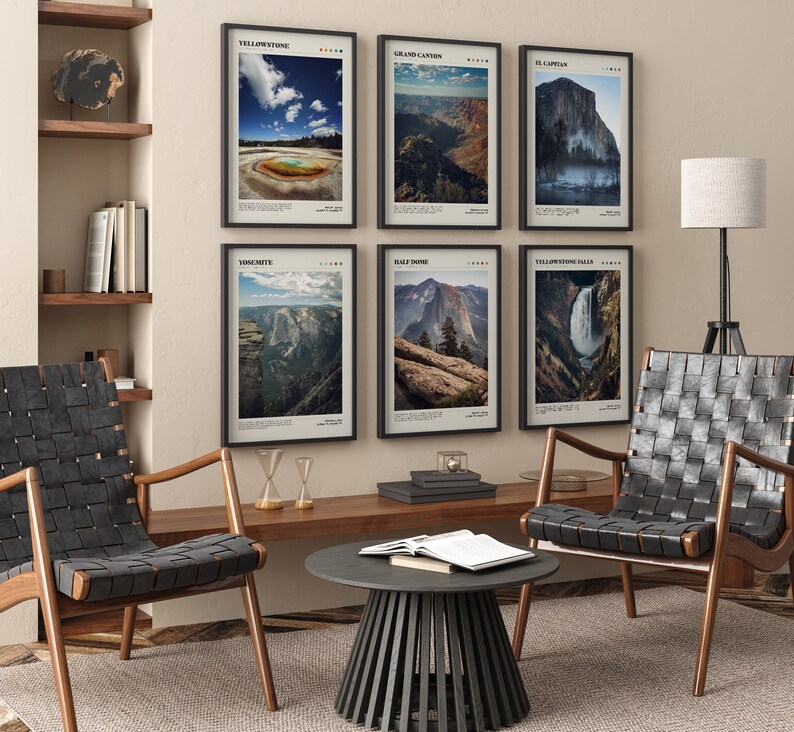 May include: Six framed landscape prints featuring national parks, including Yellowstone and Yosemite. The prints have black frames and are displayed on a beige wall above a wooden table and two black leather chairs. The room is decorated in a modern style.