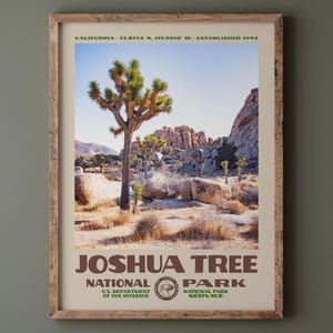 May include: A framed print of Joshua Tree National Park. The image features a Joshua tree in a desert landscape under a blue sky. The print includes the park's name, the National Park Service logo, and the text "CALIFORNIA - 33.8734 N. 115.9010 W - ESTABLISHED 1994."