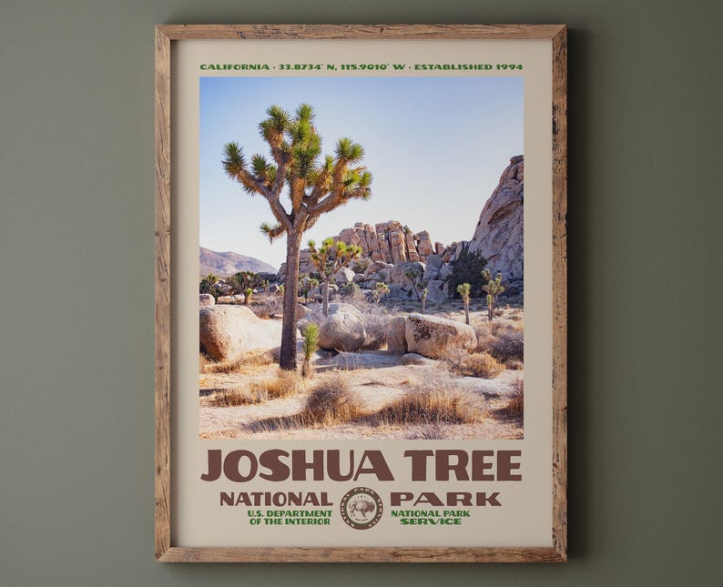 May include: A framed print of Joshua Tree National Park. The image features a Joshua tree in a desert landscape under a blue sky. The print includes the park's name, the National Park Service logo, and the text "CALIFORNIA - 33.8734 N. 115.9010 W - ESTABLISHED 1994."