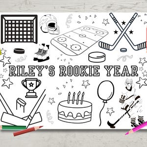May include: A black and white colouring page featuring a hockey theme. The page includes a hockey net, hockey sticks, a hockey player, a birthday cake, a trophy, and the text "RILEY'S ROOKIE YEAR".